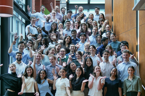 65 new medical interns for 2025 standing on stairs celebrating and smiling at camera at Austin Health